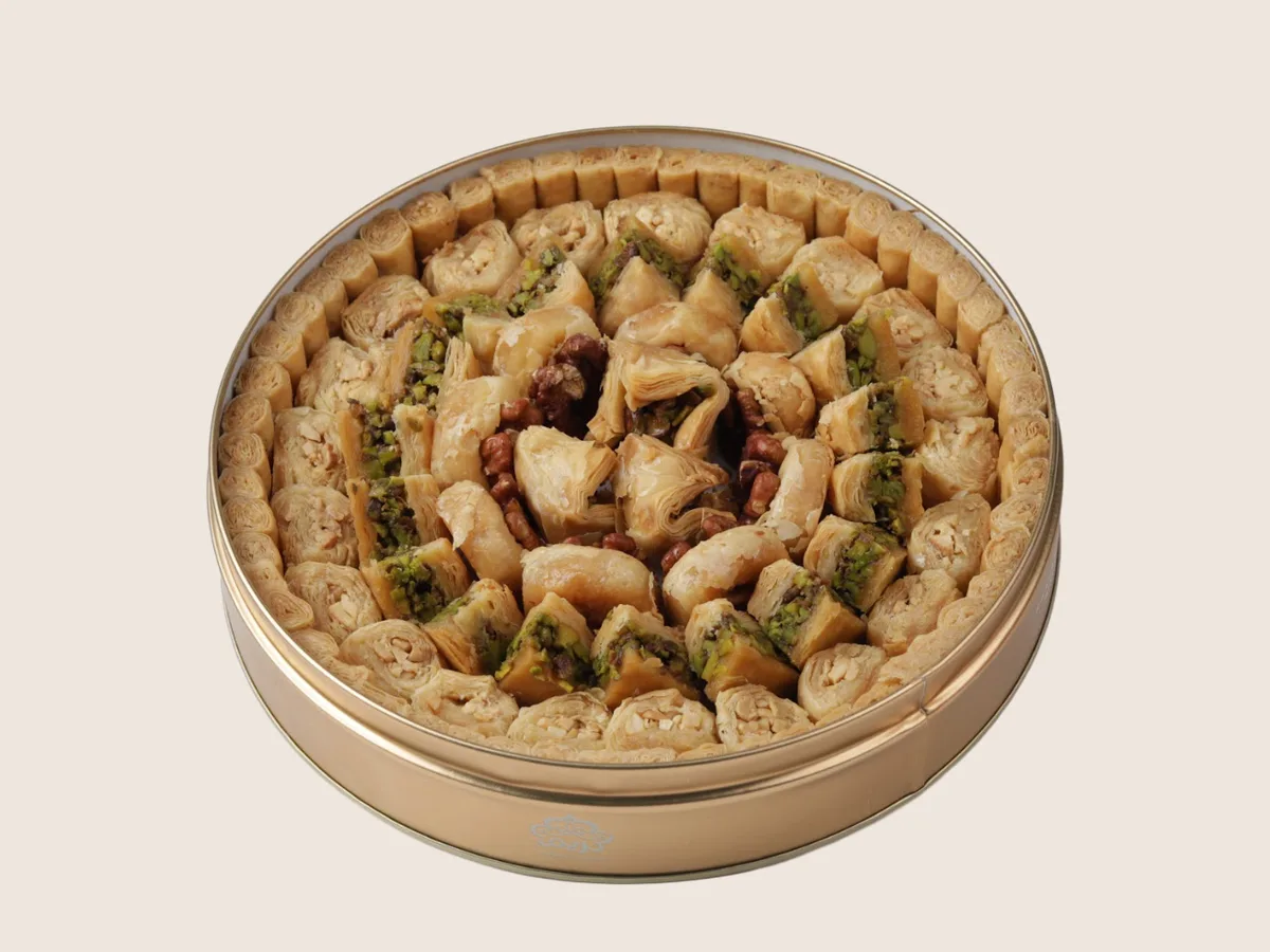 Assorted baklava in a round gold tin